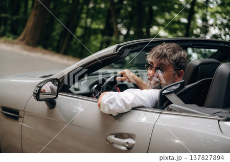 Stylish senior man is in convertible cabriolet car 137827894