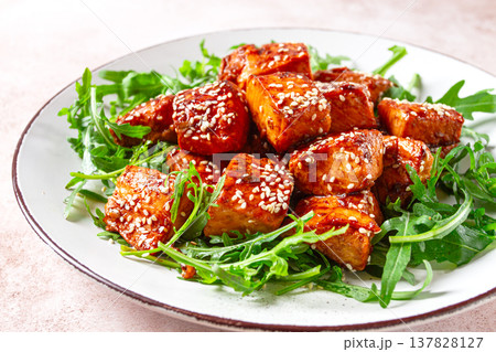fried salmon slices, teriyaki with sesame seeds, with arugula salad, top view, fried salmon slices, teriyaki with sesame seeds, with arugula salad, top view, 137828127