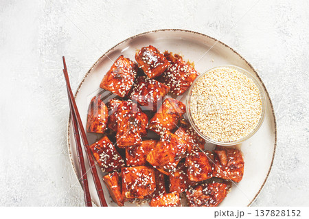 fried pieces of salmon teriyaki with sesame seeds, top view, 137828152