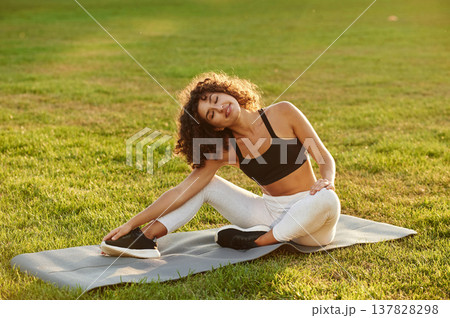 Friendly, positive facial expression, smiling. Young fitness woman is on the field outdoors 137828298