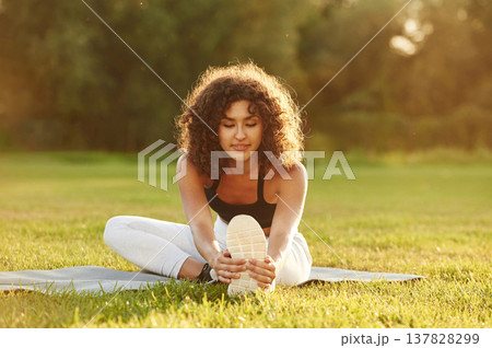 Young fitness woman is on the field outdoors 137828299