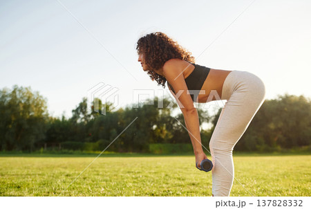 Young fitness woman is on the field outdoors 137828332