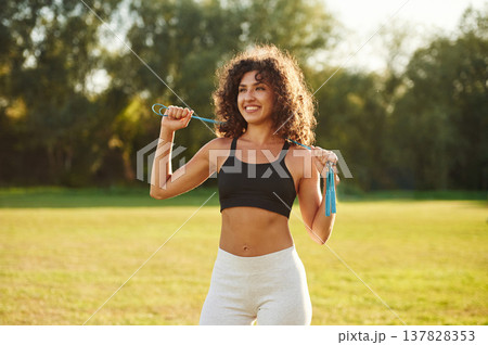 Good attitude, standing. Young fitness woman is on the field outdoors 137828353