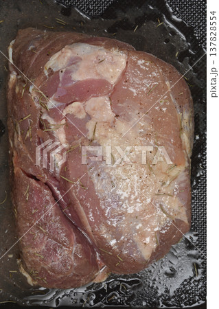 Close up of raw seasoned pork meat with rosemary Close up of raw seasoned pork meat with rosemary 137828554
