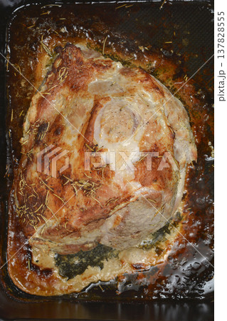 Roasted pork meat with rosemary in a baking pan 137828555