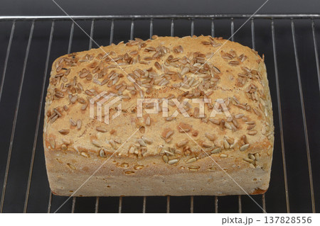 Whole grain bread with sunflower seeds on cooling rack 137828556