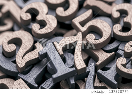 Pile of old wooden numbers in vintage style. Mathematics, education and learning concept. Pile of old wooden numbers in vintage style. Mathematics, education and learning concept. 137828774