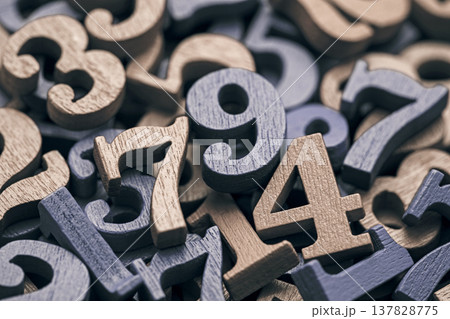 Pile of old wooden numbers in vintage style. Mathematics, education and learning concept. Pile of old wooden numbers in vintage style. Mathematics, education and learning concept. 137828775