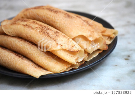 Delicious Homemade Bengali Patisapta Pitha Sweets Placed on a Dark Plate Delicious Homemade Bengali Patisapta Pitha Sweets Placed on a Dark Plate 137828923