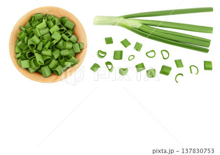 Green onion in wooden bowl isolated on the white background. Top view with copy space for your text. Flat lay. Green onion in wooden bowl isolated on the white background. Top view with copy space for your text. Flat lay. 137830753