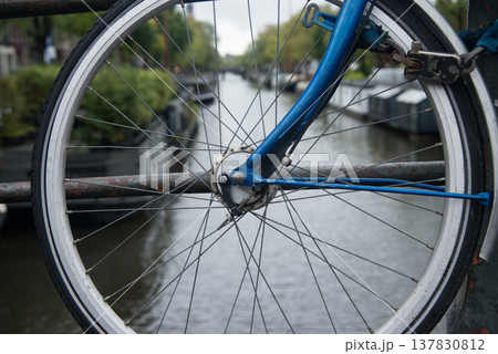 Bicycle parked on a bridge in Amsterdam. Bicycle parked on a bridge in Amsterdam. 137830812