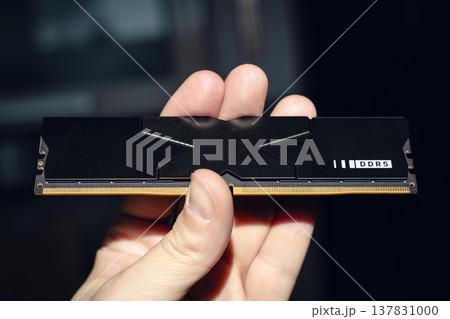 Fast DDR5 memory module held in hand. 137831000