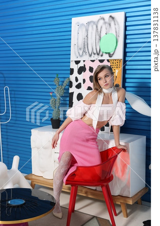 Casual scene of creative woman reclining with her notebook in cozy studio Casual scene of creative woman reclining with her notebook in cozy studio 137831138