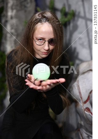 Glow sphere held by woman, Woman with luminous orb in hand 137831145