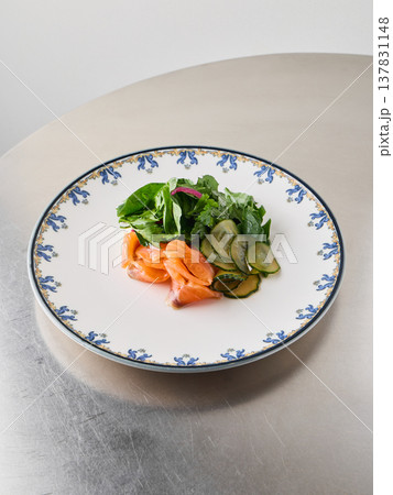 Delicious smoked salmon salad with crisp cucumber and fresh greens 137831148