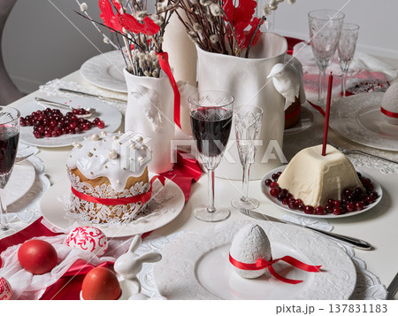 Red and white festive dessert table with candles and painted eggs Red and white festive dessert table with candles and painted eggs 137831183
