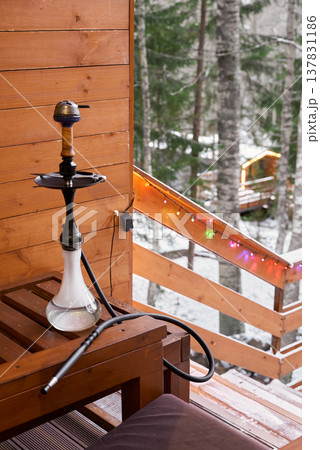 Calm environment with hookah positioned next to snowcovered trees 137831186