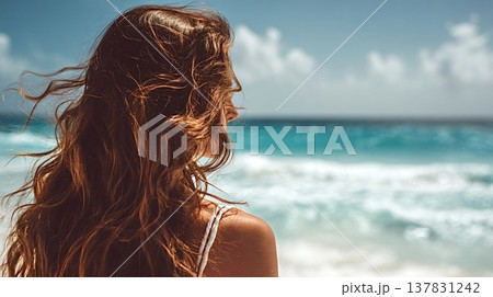 Woman admiring ocean view contemplating beach vacation 137831242