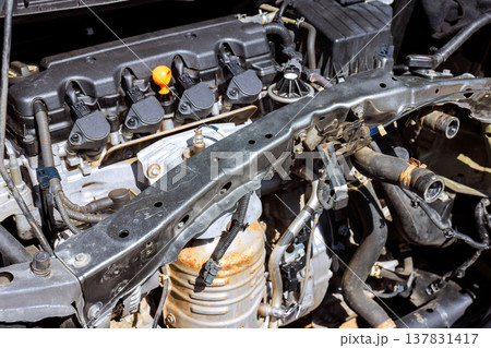Engine components are visible in car during repair in workshop setting 137831417