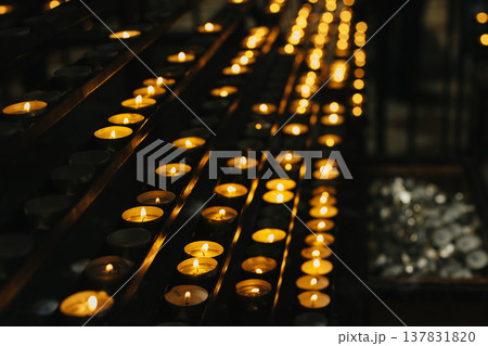 Burning candles in an old church. Burning candles in an old church. 137831820