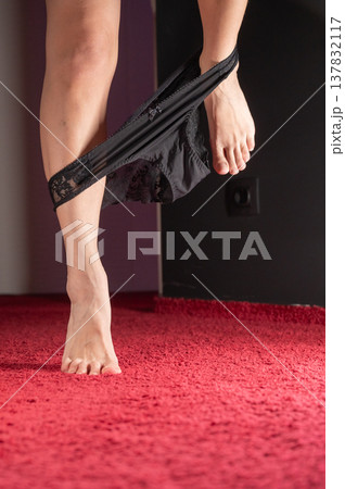 Foot fetish. A woman takes off her black lace panties. Foot fetish. A woman takes off her black lace panties. 137832117