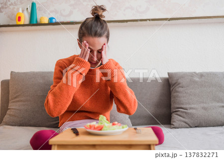 Woman struggling with an eating disorder and food problems Woman struggling with an eating disorder and food problems 137832271