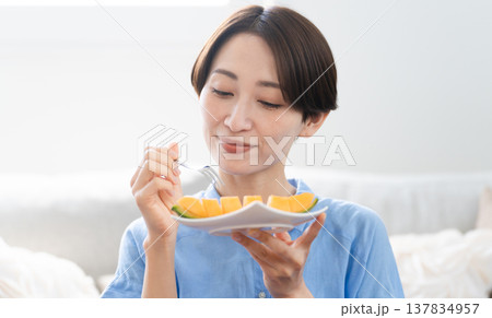 メロンを食べる若い女性 ライフスタイルイメージ メロンを食べる若い女性 ライフスタイルイメージ 137834957