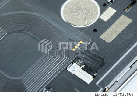 High-angle macro of circuit board, dual camera modules, and wireless charging coil 137836663