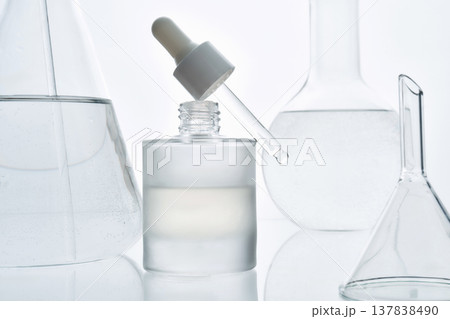 Modern laboratory skincare concept with glass dropper and cosmetic serum bottle Modern laboratory skincare concept with glass dropper and cosmetic serum bottle 137838490