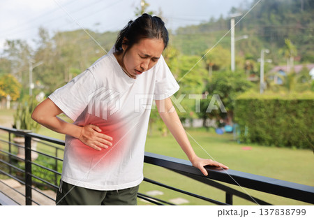 Woman holding her stomach with red highlight. Abdominal pain, liver disease, kidney pain, appendicitis and stomach ache concept for health care and medical treatment. Woman holding her stomach with red highlight. Abdominal pain, liver disease, kidney pain, appendicitis and stomach ache concept for health care and medical treatment. 137838799