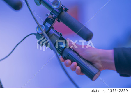 Close-up of Cameraman Hand Operating Professional Camera Rig at Event with copy space 137842829