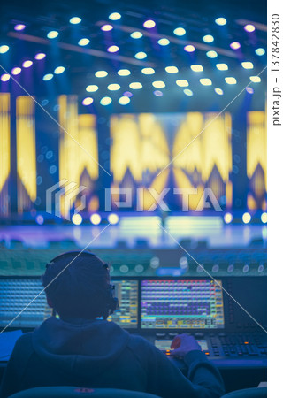 Professional Operator Working at Control Console During Live Show with copy space 137842830
