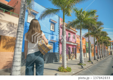 Young Woman Traveler Walking on Colorful Street in Santa Cruz de Tenerife with copy space 137842833