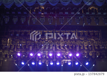 Professional Stage Lighting Rig with Purple and Blue Spotlights in Dark with copy space 137842879