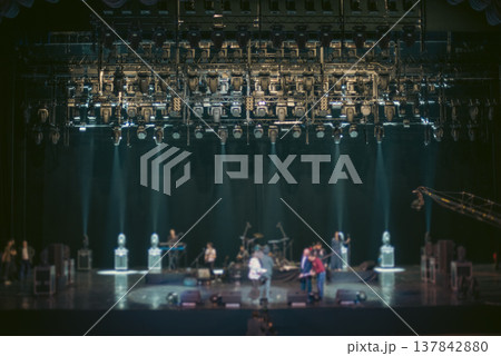 Concert Stage with Professional Lighting Rig and Crew during Soundcheck with copy space Concert Stage with Professional Lighting Rig and Crew during Soundcheck with copy space 137842880