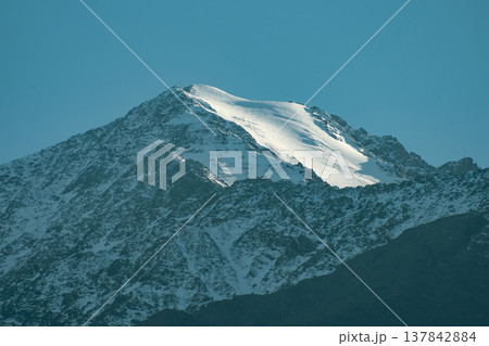 Majestic Mountain Peak with White Glacier and Clear Blue Sky with copy space. Majestic Mountain Peak with White Glacier and Clear Blue Sky with copy space. 137842884
