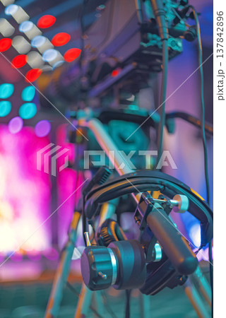 Professional Broadcast TV Camera Setup on Tripod with Stage Bokeh and Copy Space Professional Broadcast TV Camera Setup on Tripod with Stage Bokeh and Copy Space 137842896
