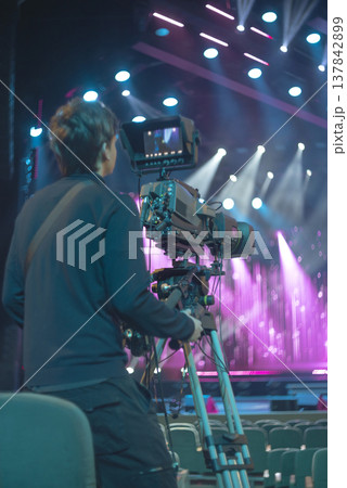 Professional Cameraman Operating Broadcast TV Camera at Music Concert with Copy Space Professional Cameraman Operating Broadcast TV Camera at Music Concert with Copy Space 137842899