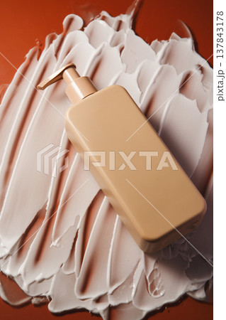 Pump Lotion Bottle on Orange Cream 137843178