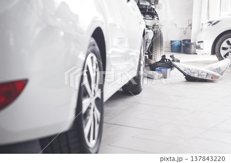 Replacing the front lights on car in service station. Replacing the front lights on car in service station. 137843220
