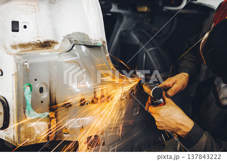 Cleaning of weld. Processing of welding seams pneumatic grinding machine with an abrasive wheel. Repair of car body. Cleaning of weld. Processing of welding seams pneumatic grinding machine with an abrasive wheel. Repair of car body. 137843222