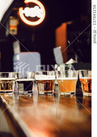 Selection of Various Beer Types Displayed on Bar Counter in Pub 137843256