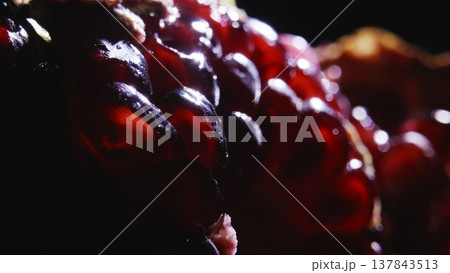 A juicy red pomegranate in the sun's rays. A juicy red pomegranate in the sun's rays. 137843513