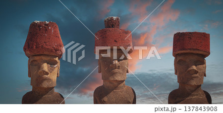 Ancient Moai statues with red pukao hats at Ahu Nau Nau on Easter Island with copy space 137843908