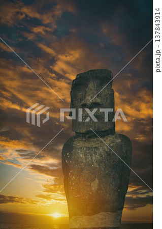Ancient Moai statue at golden sunset on Easter Island with copy space 137843914