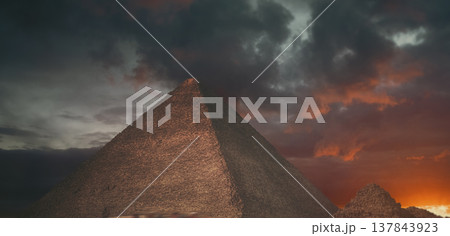 Great Pyramid of Giza under dramatic sunset sky with orange clouds and copy space Great Pyramid of Giza under dramatic sunset sky with orange clouds and copy space 137843923