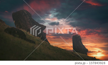 Two Moai statues silhouettes on Easter Island at fiery sunset with copy space 137843928