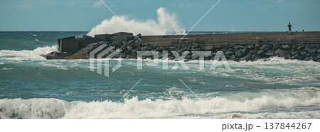 Powerful Atlantic Wave Crashing on Stone Breakwater with Silhouette and Copy Space Powerful Atlantic Wave Crashing on Stone Breakwater with Silhouette and Copy Space 137844267