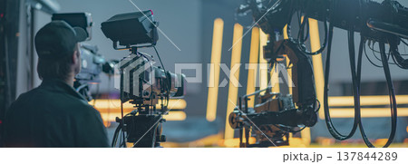 Live broadcasting production process in modern news studio with professional camera and copy space Live broadcasting production process in modern news studio with professional camera and copy space 137844289