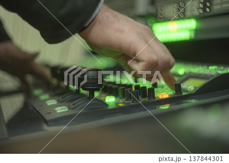Operator hand pressing button on professional video switcher in news studio with copy space 137844301